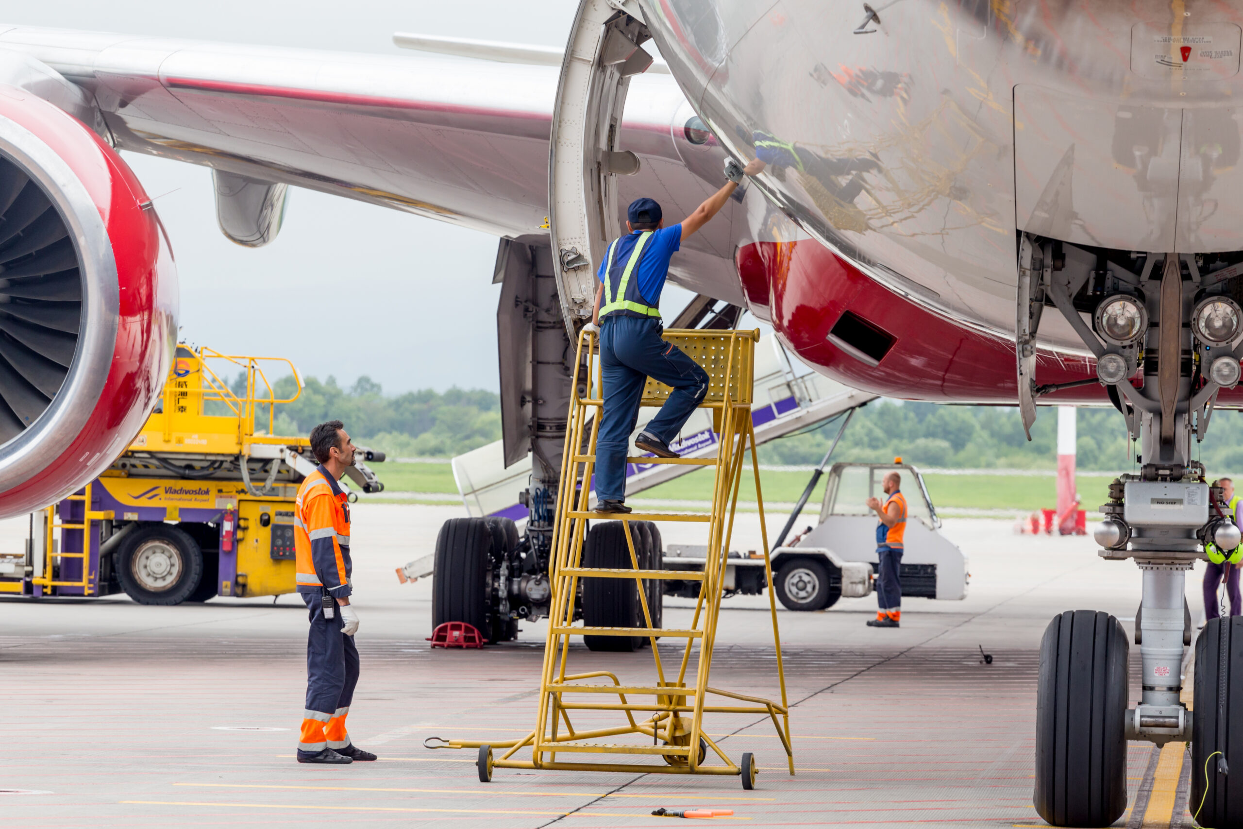Aircraft Maintenance Engineers Inspecting a Boeing 777-300 During Routine MRO Operations Aircraft Maintenance Engineers Inspecting a Boeing 777-300 During Routine MRO Operations